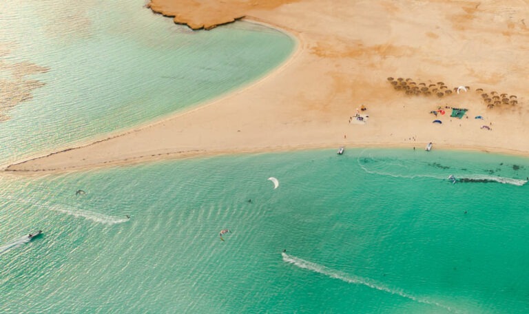 Tawila Island in the Red Sea with kitesurfers gliding over turquoise lagoons and sandy shores