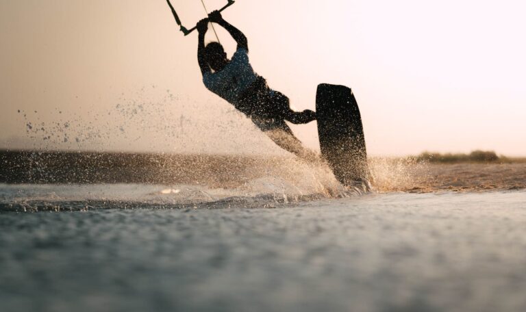 Kitesurfer performing a jump trick during kite camp in Egypt