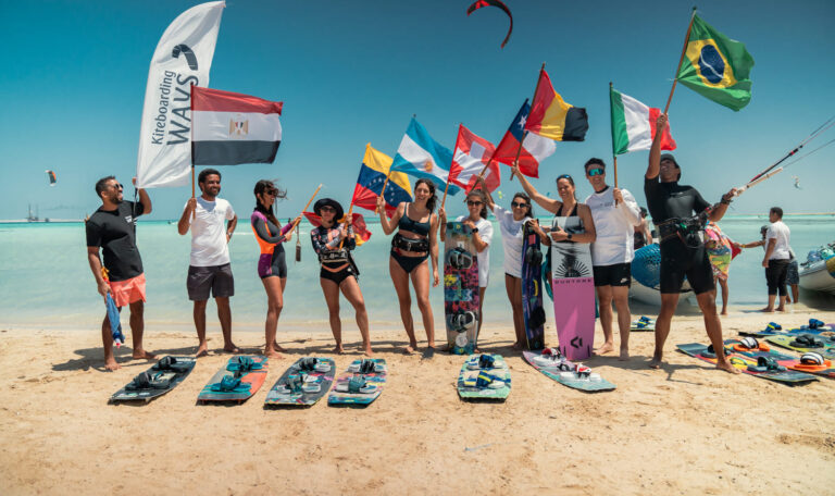 International kitesurfing riders at Kiteboarding Ways El Gouna with flags on the beach
