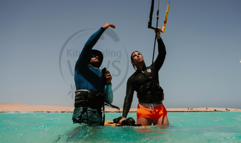 Certified kitesurfing instructor guiding a beginner during a safety-focused kiteboarding lesson in El Gouna